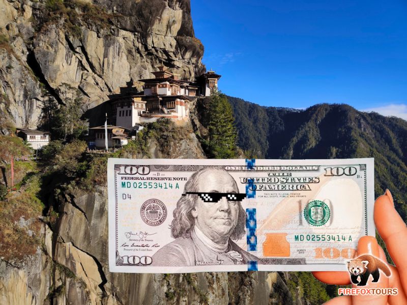 100 USD dollar notes with Tiger's Nest of Bhutan as background